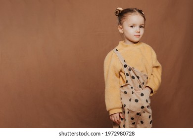 Portrait Of A Cute Funny Girl With A Beautiful Hairstyle And Stylish Clothes On A Solid Background