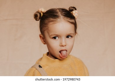 Portrait Of A Cute Funny Girl With A Beautiful Hairstyle And Stylish Clothes On A Solid Background