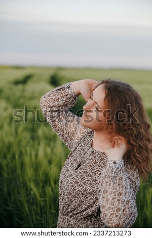 Similar – Junge Frau genießt die Sonne auf einer grünen Wiese