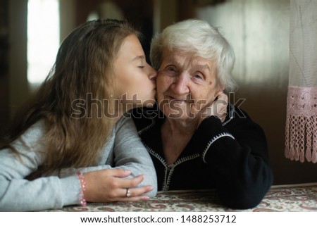 Similar – Young woman talking to elderly woman in wheelchair