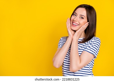 Portrait of cute gorgeous girl straight hairstyle wear striped t-shirt palms on cheekbones smiling isolated on yellow color background - Shutterstock ID 2218831225