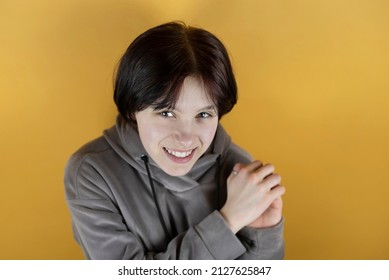 Portrait Of A Cute Happy Teen Girl With A Smile And Emotions Of Joy, Top View. The Girl Has Short Painted Burgundy Hair And Healthy White Teeth. The Girl Is Happy Because She Has A Good Family