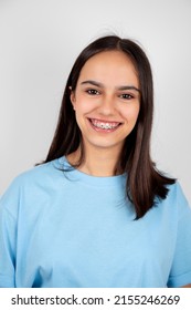 Portrait Of A Cute And Happy Teen Girl With Braces Smiling. Isolated On White