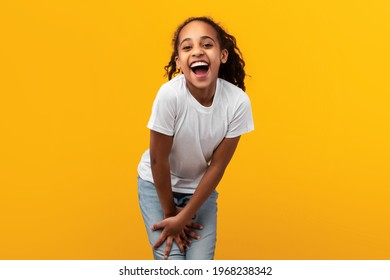 Portrait Of Cute Joyful African American Girl Laughing, Looking And Smiling At Camera, Young Child Posing Isolated Over Yellow Studio Background With Free Copy Space, Banner