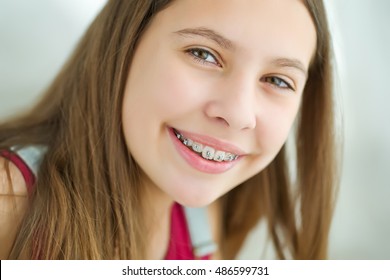 Portrait Of Cute Kid With Dental Braces Smiling.