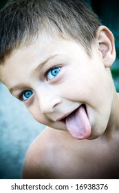 Portrait Of Cute Kid Sticking His Tongue Out