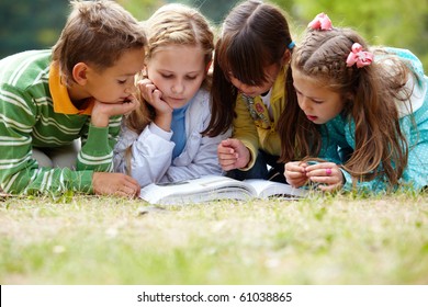 Portrait of cute kids reading book in natural environment together - Shutterstock ID 61038865