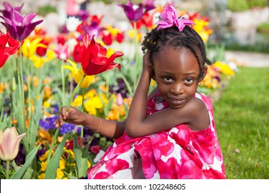 Portrait Of A Cute Little African American Girl Playing In The Garden