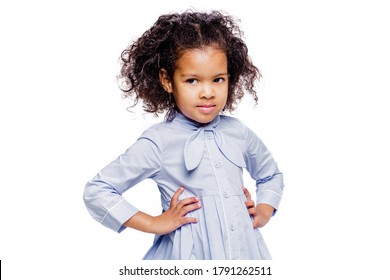 Portrait of a cute little african american girl in a blue dress, isolated on white background