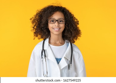 Portrait of cute little african girl dressed like doctor isolated on yellow background - Powered by Shutterstock