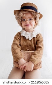 Portrait Of Cute Little Baby Cosplaying The Old Lady Outfit. Baby Girl Wearing Grandma Costume