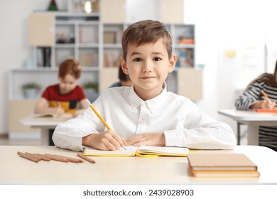 Portrait of cute little boy studying in classroom at school - Powered by Shutterstock