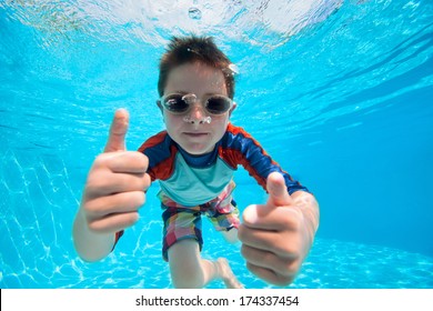 Portrait of a cute little boy swimming underwater - Powered by Shutterstock