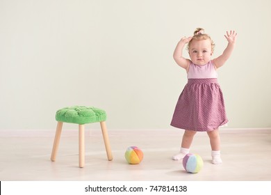 Portrait of a cute little girl in a pink dress