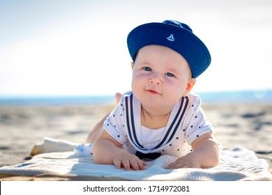 Portrait Of A Cute Newborn Baby Lying On Her Stomach On Tropical Beach. Family Summer Vacation. Ocean And Island Fun. Travel With Young Children