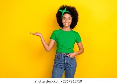 Portrait of cute nice girl toothy smile arm palm hold demonstrate empty space proposition isolated on yellow color background - Shutterstock ID 2367365719