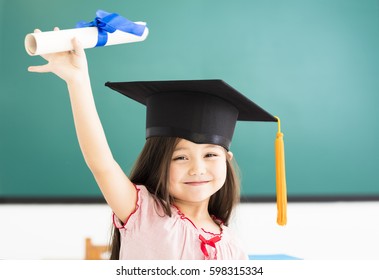 Portrait of  cute schoolgirl with graduation hat in classroom - Powered by Shutterstock