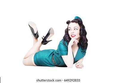 Portrait of Cute Sexy Brunette with black hair. Pin up Female Dressed in military clothing Uniform and Garrison cap with legs in the air. Army Pin-up Girl Concept