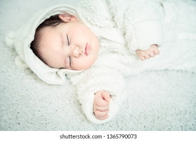 A portrait of a cute sleeping baby. Happiness, parenthood. Goods for newborns.