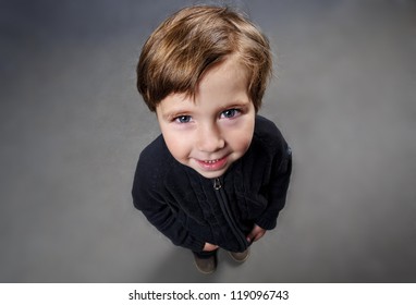 Portrait Of Cute Small Boy Looking Up.