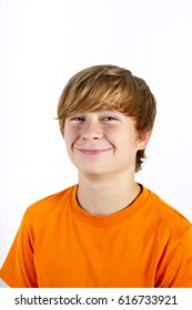 Portrait Of Cute Smiling Boy With Orange Shirt