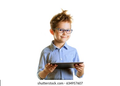 Portrait Of A Cute Smiling Boy Using A Tablet Computer Against A White Background. Child In Glasses With A Laptop, Isolated. Smart Kid Tells Us About Science.