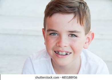 Portrait of a cute smiling child with freckles 