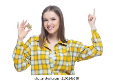 Portrait Of Cute Smiling Girl With A Physical Bitcoin Cryptocurrency Standing With A Raised Hand Isolated On White Background. Concept Of Financial Literacy, Innovation, Success, Wealth