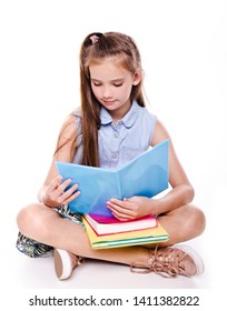 Portrait Of Cute Smiling Happy Little School Girl Child Teenager Sitting On A Floor And Reading The Book Isolated On A White Background Education Concept