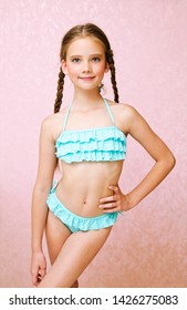 Portrait of cute smiling little girl child schoolgirl teenager in swimsuit isolated fashion concept