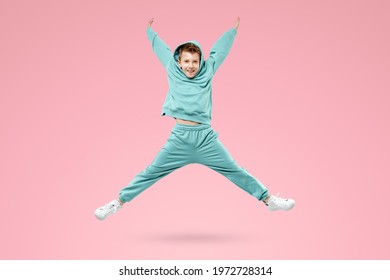 Portrait, cute stylish boy in a blue suit on a pink background. Studio portrait of a child, modern design, trendy background, turquoise. Copy space
