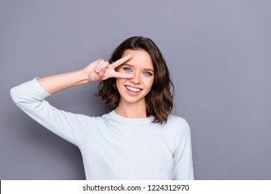 Portrait Of Cute Sweet Gorgeous Nice Lady With Her Brunette Hairstyle She Give V-sign Near Eye Make Hollywood White Smile Stand Isolated On Gray Background