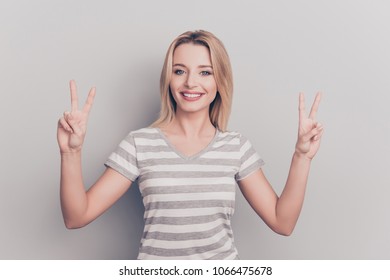 Portrait of cute tender lovely in good mood successful confident charming beautiful attractive adorable rejoicing with beaming smile entrepreneur demonstrating two fingers isolated on gray background