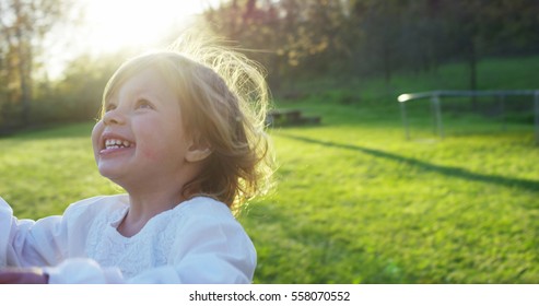 A Portrait Of Cute Toddler Little Two Years Old Girl Running Happy On Green Widow In A Woods. Concept Of Love For Nature, Protection Of Kids,innocence, Fun, Joy, Carefree Childhood, Freedom