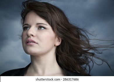 Portrait of a cute woman with her hair blowing in the wind