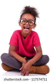 Portrait Of A Cute Young African American Girl Seated On The Floor