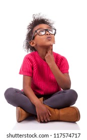 Portrait of a cute young African American girl seated on the floor