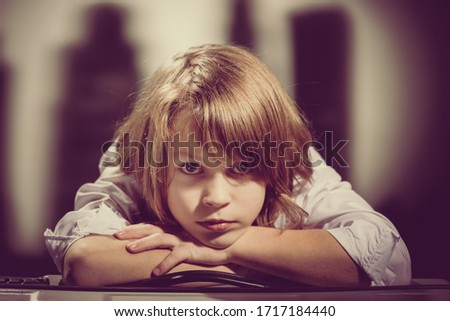 Portrait of cute young boy dreaming. Retro or vintage style
