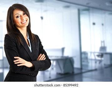 Portrait Of A Cute Young Business Woman Smiling, In An Office Environment