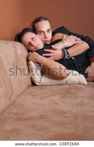 Similar – Joyful couple laughing together on a vintage sofa