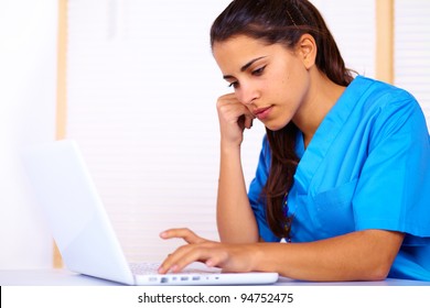 Portrait Of A Cute Young Nurse Using A Laptop.