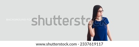 Portrait of a cute young woman with long hair, healthy hair. Gray background for caption text.