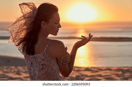 Portrait of cute young woman on the beach during the sunset - Powered by Shutterstock