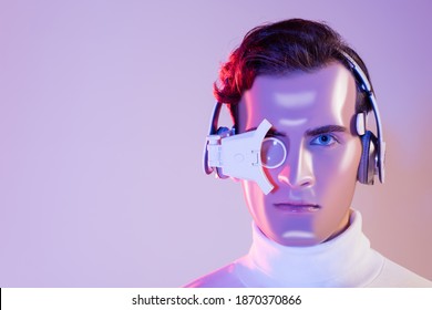 Portrait of cyborg in headphones and digital eye lens on purple background