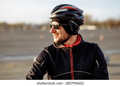 Portrait Of A Cyclist In A Black Helmet And Goggles