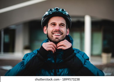   Portrait Of The Cyclist Fastening His Protective Helmet. Happy Young Man Prepares For Deliveries Home. Portrait, Cyclist, Home Delivery