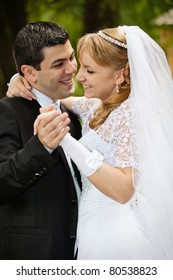 Portrait Dancing Wedding Couple At A Park On A Sunny Day