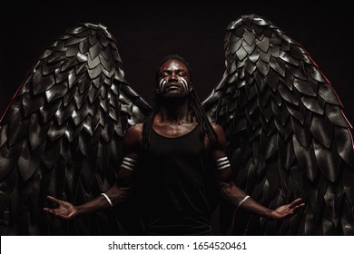 portrait of dark angel with grand black wings on his back, black angel descended from heaven, he was bored among angels that is why suffer from pain of not being among mortals, isolated photoshot