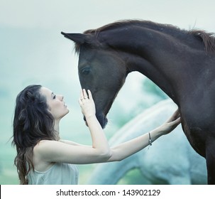 Portrait of a dark horse and woman
