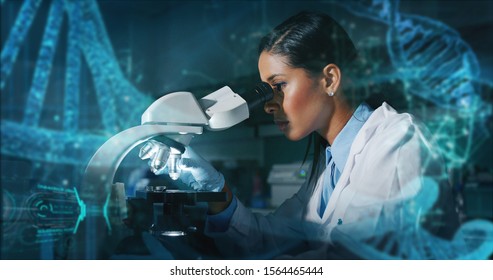 Portrait Of Dark Skin Female Scientist Is Analyzing A Sample To Extract The DNA And Molecules With Microscope In Laboratory.